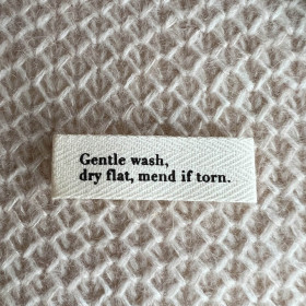 Label "Gentle wash, dry flat, mend if torn."